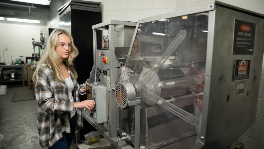 woman in front of sorting machine